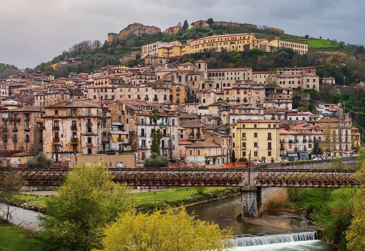 Cosenza's old town on its hill, with the Castle at the top and an iron bridge over the river